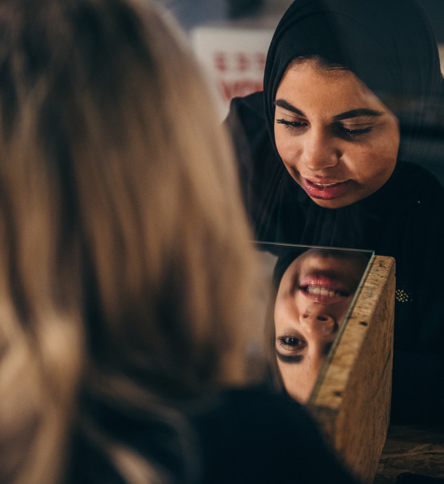 A visitor tries to draw blindfolded at the activity square of muSEEum.