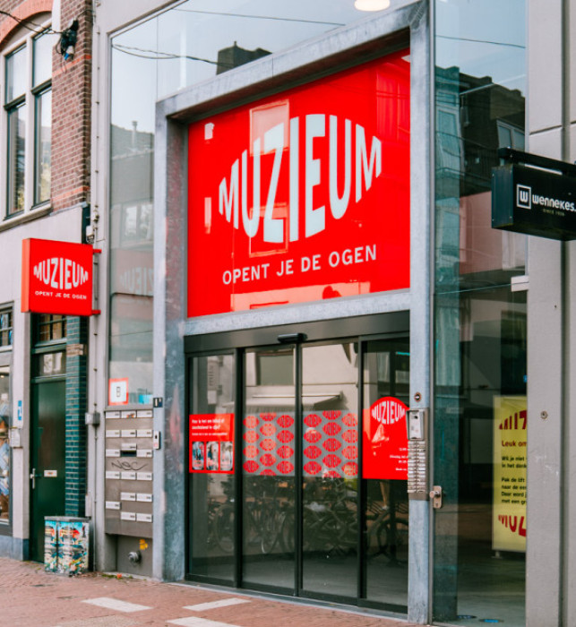 Front view of muSEEum. Red stickers with the logo and visitor information prominently displayed.